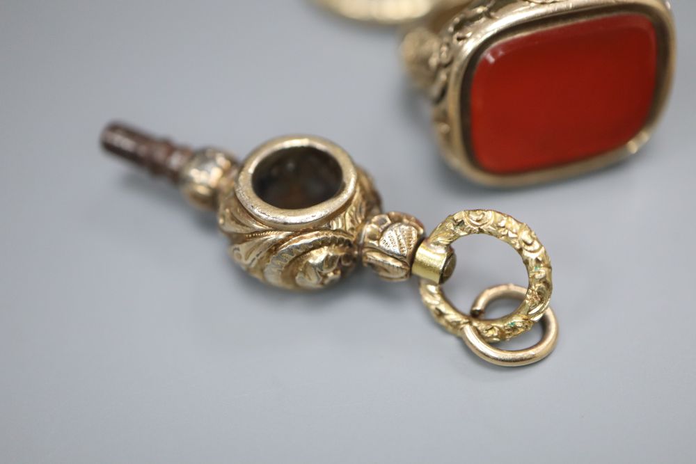A 19th century gold-cased fob seal with uncut carnelian matrix, a 19th century gold watch key and a gold-cased watch key